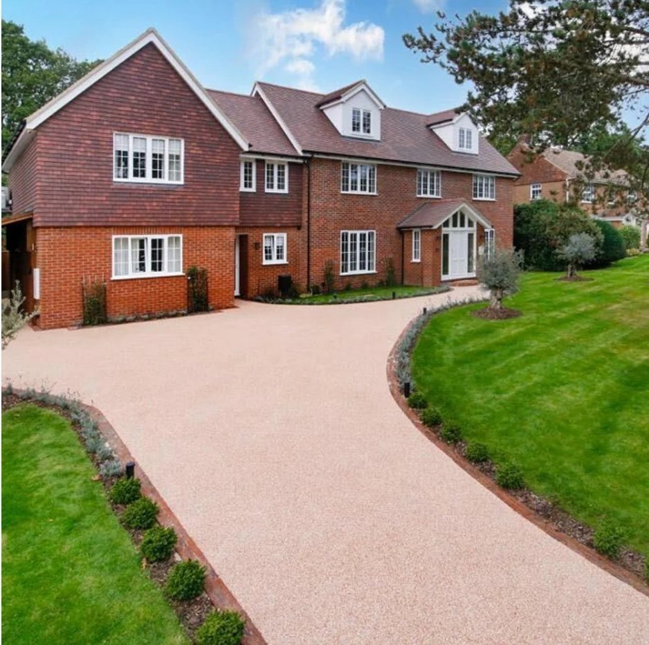 Vuba resin bonded driveway curving up to a large red-brick house